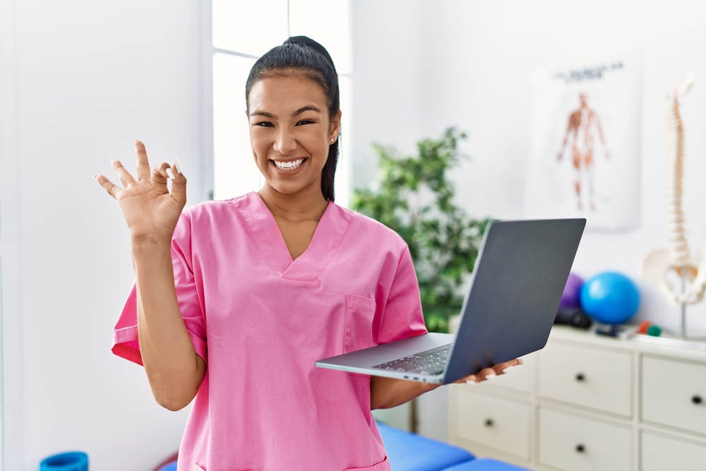 Young female physio with laptop