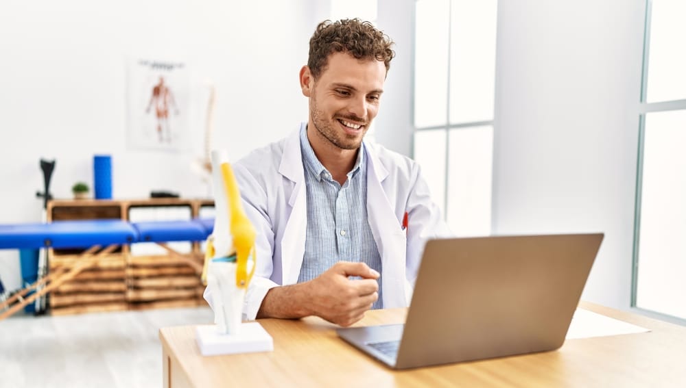 Physiotherapist using laptop